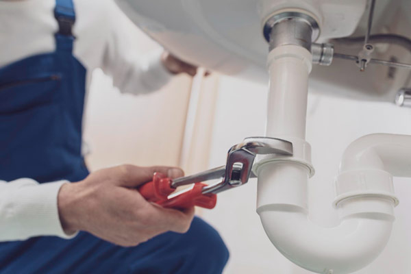 A man skillfully lays tile on a floor using a tool, ensuring precise placement and a smooth finish.